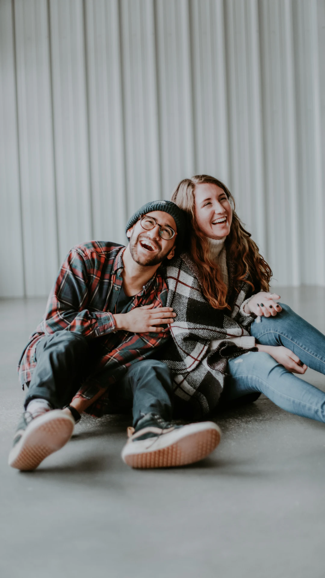 smiling woman and man sitting on floor